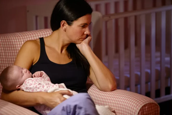 Depressed woman holding her baby