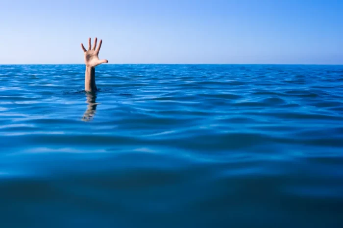 Hand sticking up out of the sea