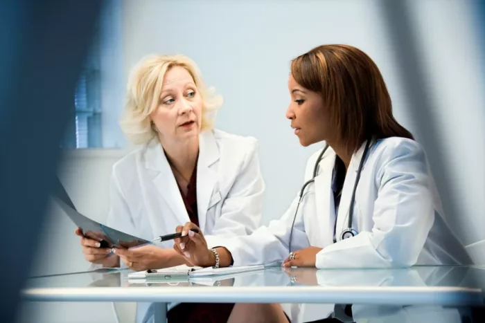 Two female medics discussing an x-ray chart