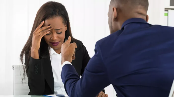 Man berating an upset woman