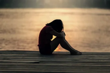 Lonely woman with anxiety on a pier