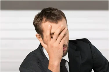 Man with head in hand after failing at something