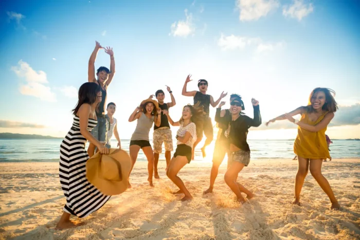 Young adults dancing on the beach